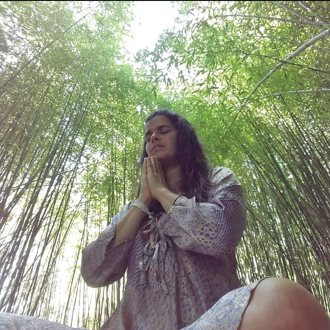 Briana meditating in a bamboo grove