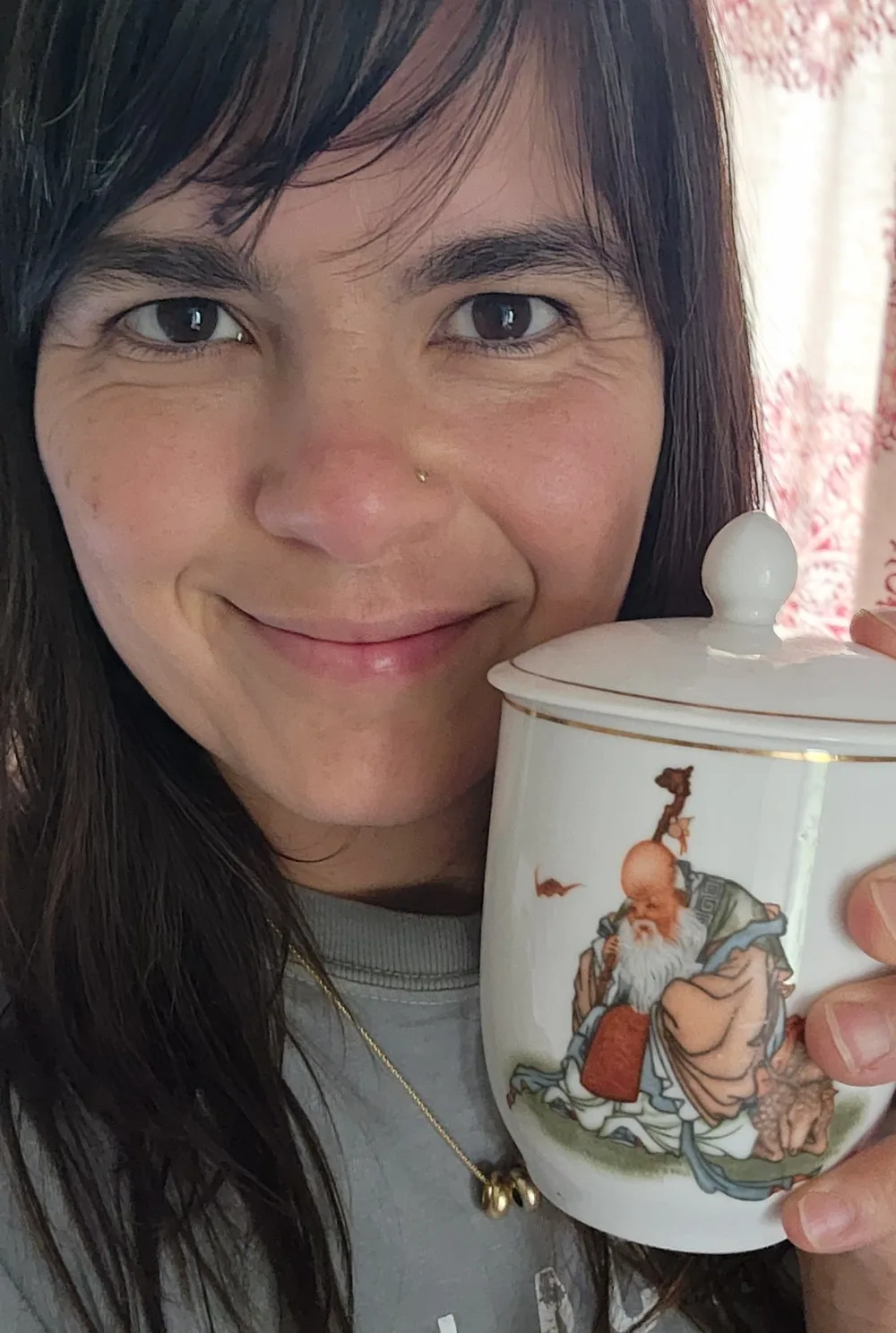 Briana J. Sabaj holding a lidded Chinese porcelain tea cup